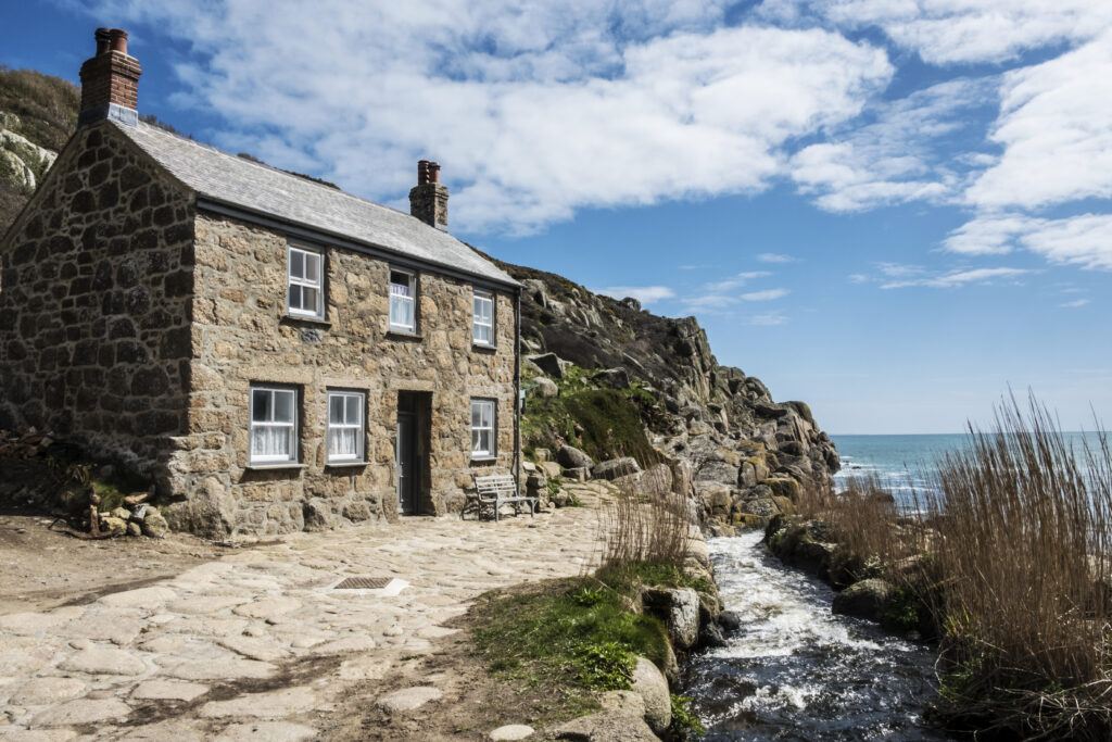 Charming stone cottage located on the coast, with scenic views of the sea and rugged landscape, ideal for property sale considerations without probate.