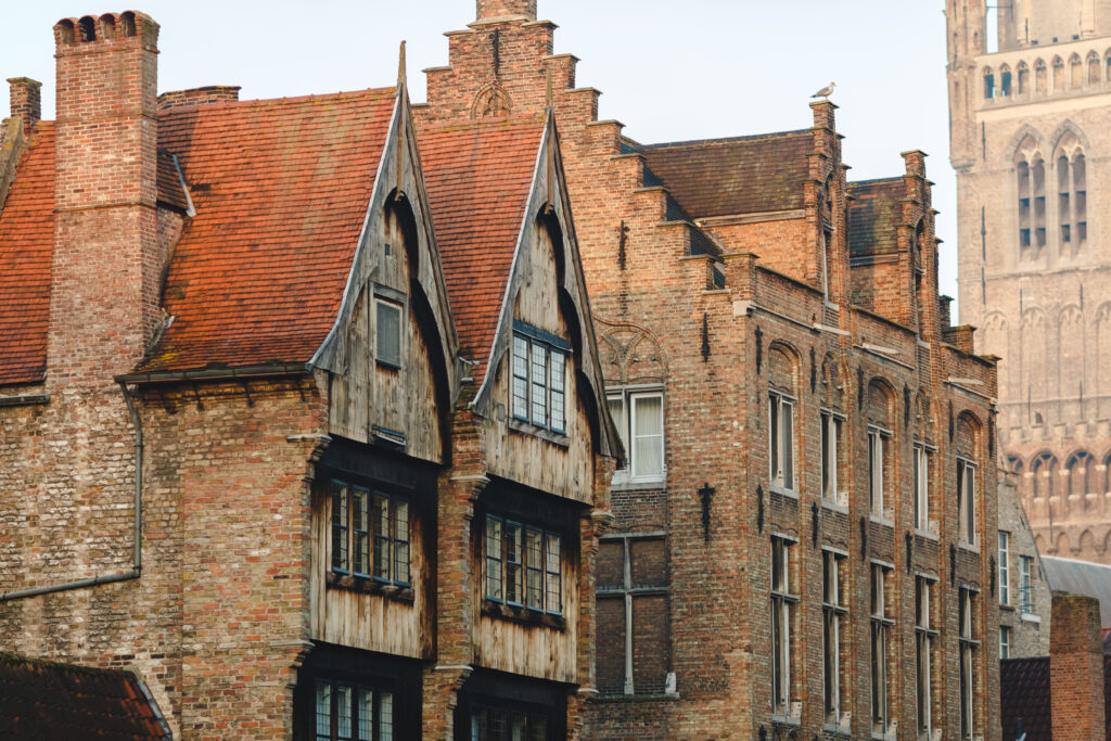 Old brick and timber houses in a historic city centre, showcasing traditional architecture.