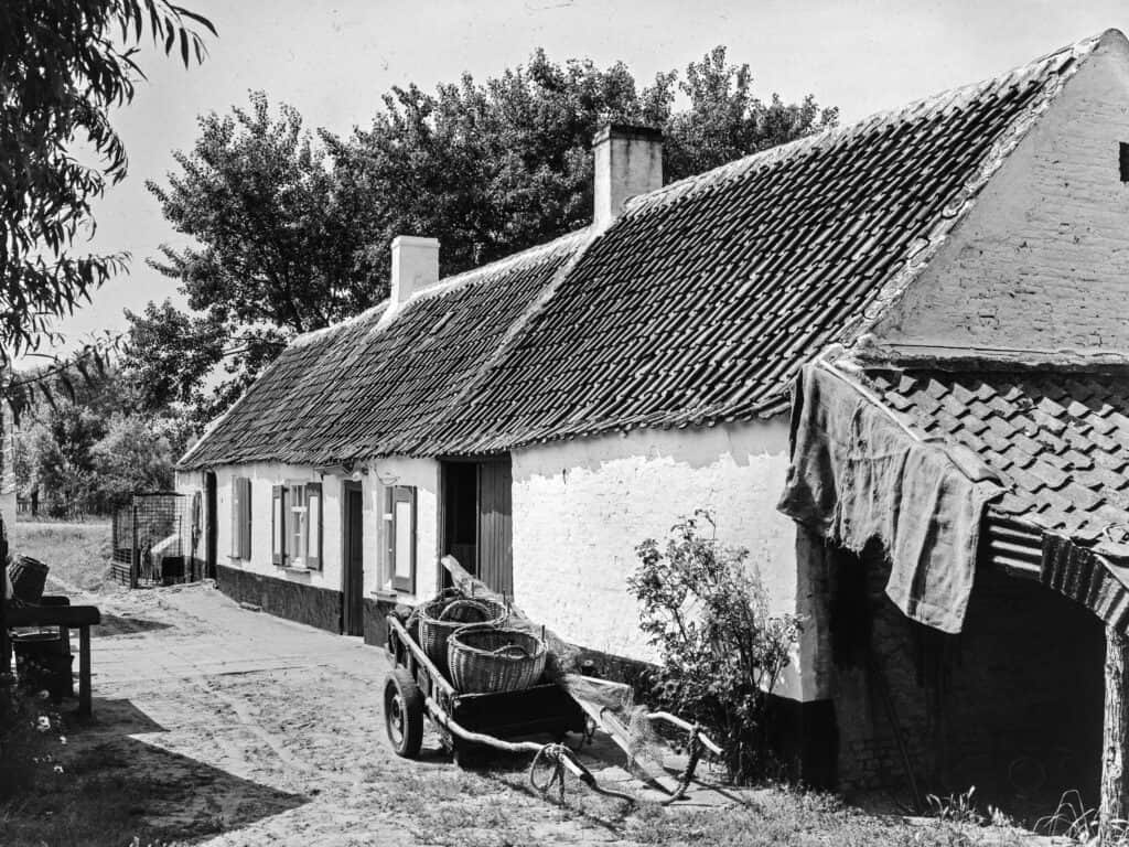 Traditional countryside cottage with a garden, wheelbarrow, and outdoor seating, illustrating rural property features and the importance of estate planning for jointly owned property.