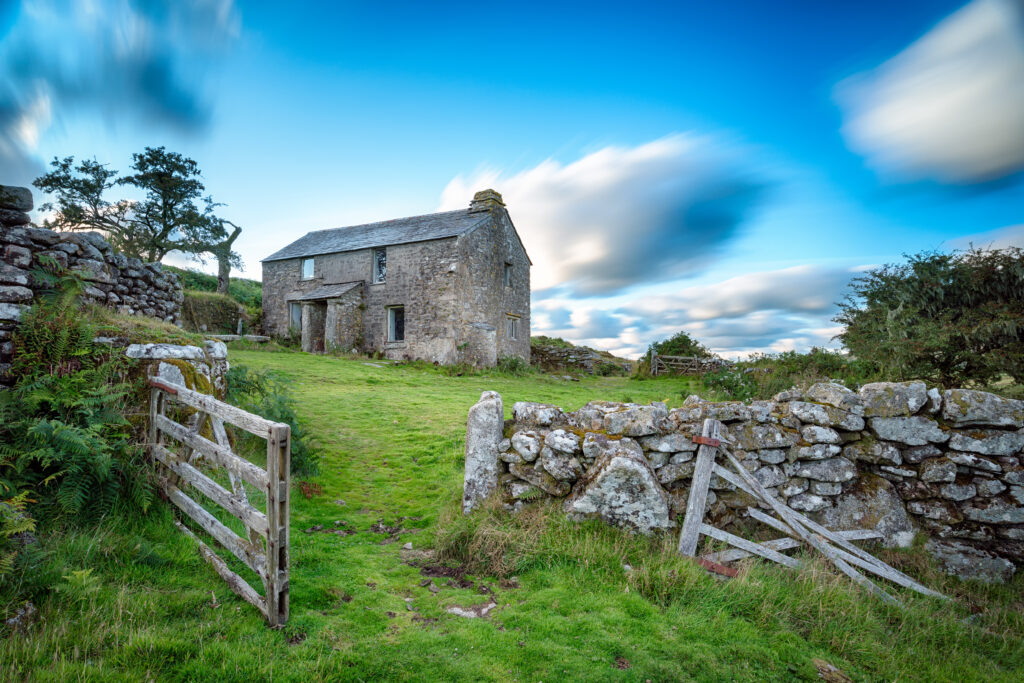 Stone cottage in rural landscape with open sky and greenery, illustrating property options and agreements.