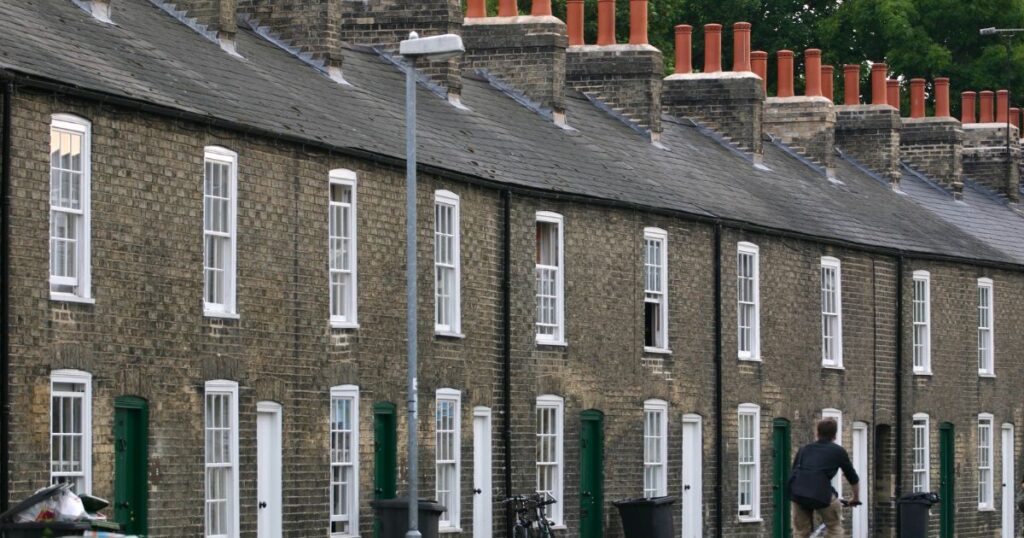 Row of traditional terraced houses in a UK neighbourhood, showcasing typical residential architecture.