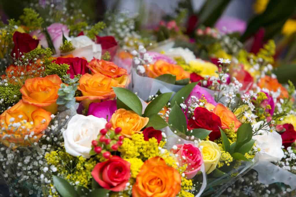 A colourful display of roses, lilies, and baby's breath arranged for a respectful farewell. Perfect for expressing sympathy and love during difficult times.