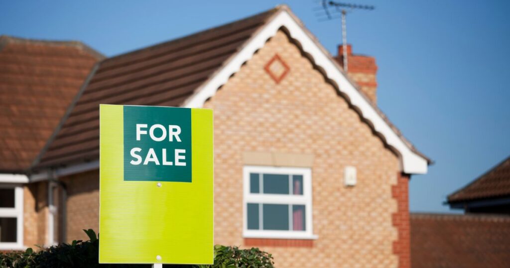 A "For Sale" sign in front of a house, highlighting the importance of understanding the reserve price in property auctions.