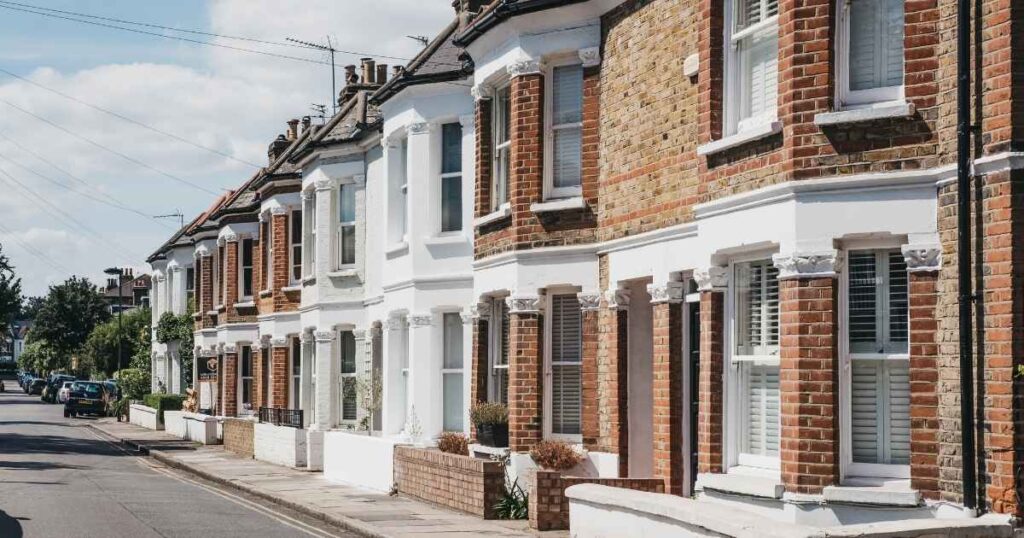 Brick terraced houses on a quiet residential street.