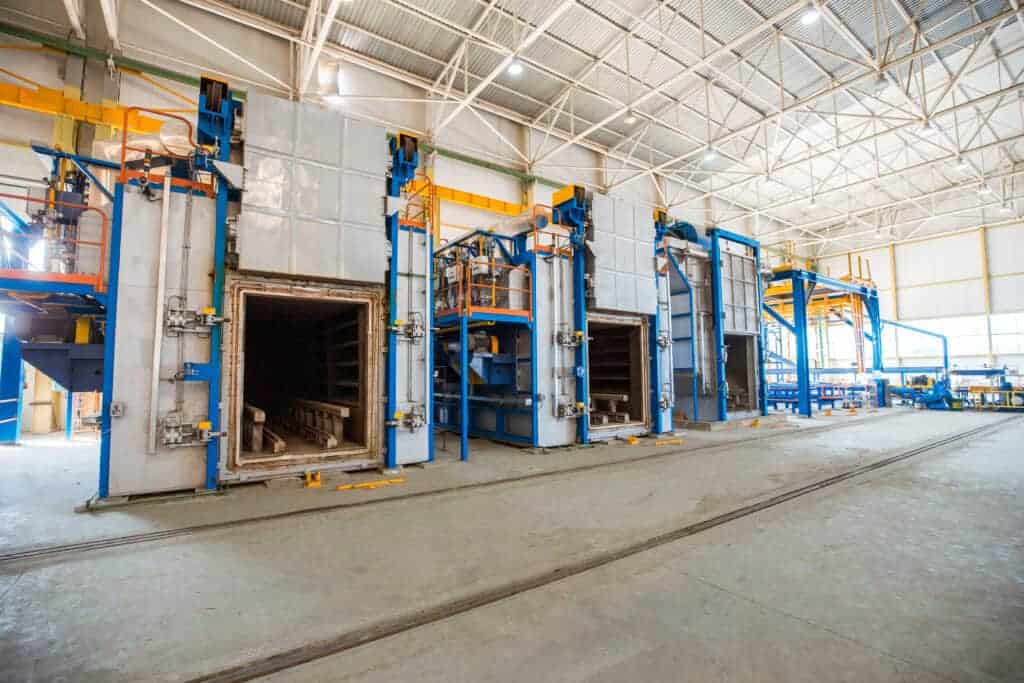 Industrial manufacturing equipment inside a spacious warehouse, ready for sale or lease, ideal for commercial property investors and business owners.