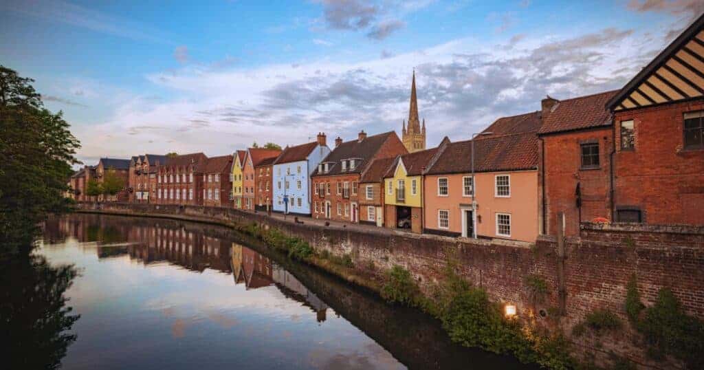 Colourful row of houses along a river with a church spire in the background, illustrating property options for inherited homes and mortgage considerations.