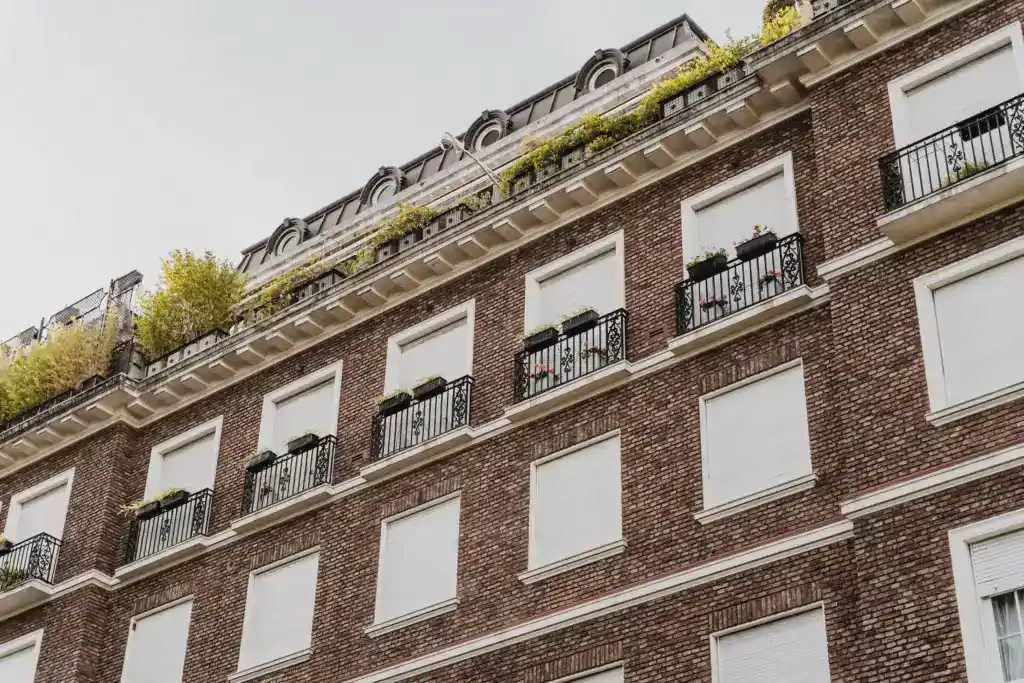 An elegant brick apartment building with balconies, illustrating property ownership and inheritance issues.
