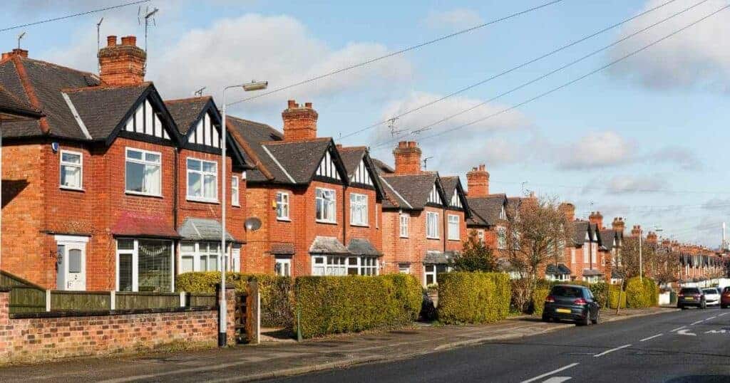 Row of traditional British terraced houses on a suburban street, illustrating property inheritance issues among siblings.