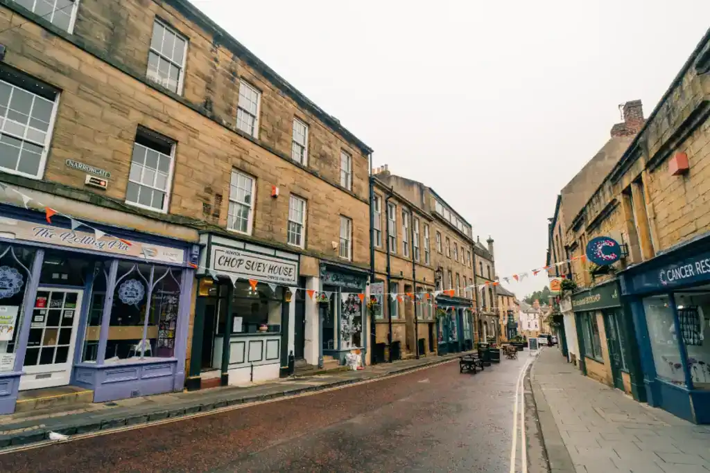 Historic street with shops and cafes in the UK.