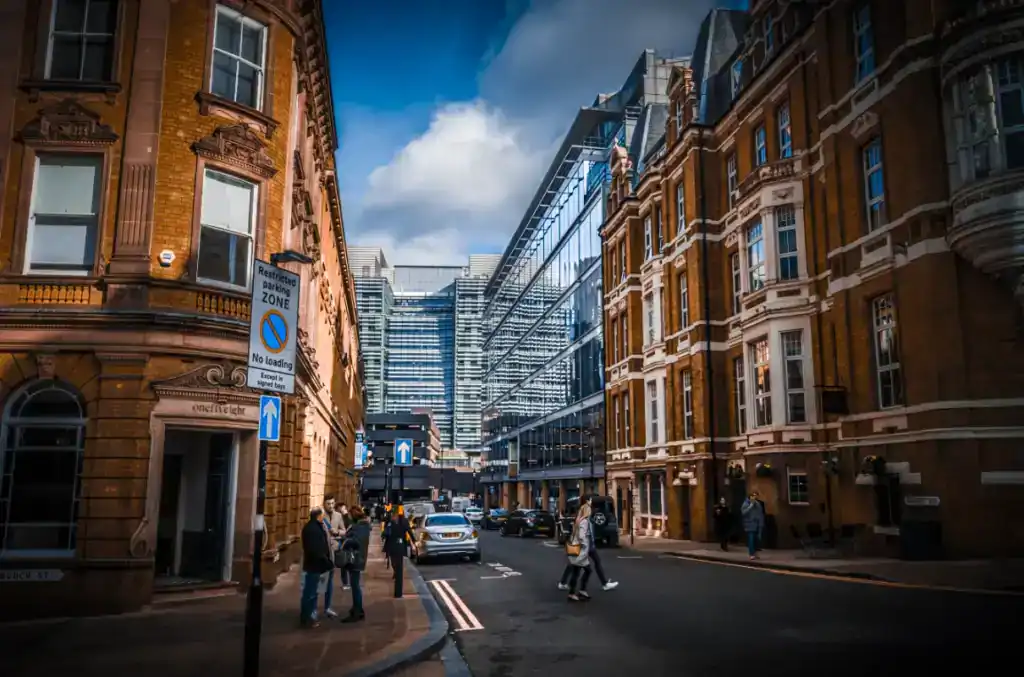 Urban street view with historic and modern buildings, showcasing commercial properties in a busy city centre.