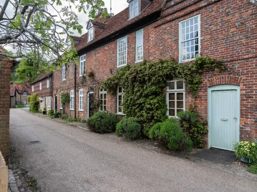 Genuine cash house buyer inspecting a traditional brick property, offering quick and reliable property sale solutions. Perfect for homeowners seeking fast cash offers.