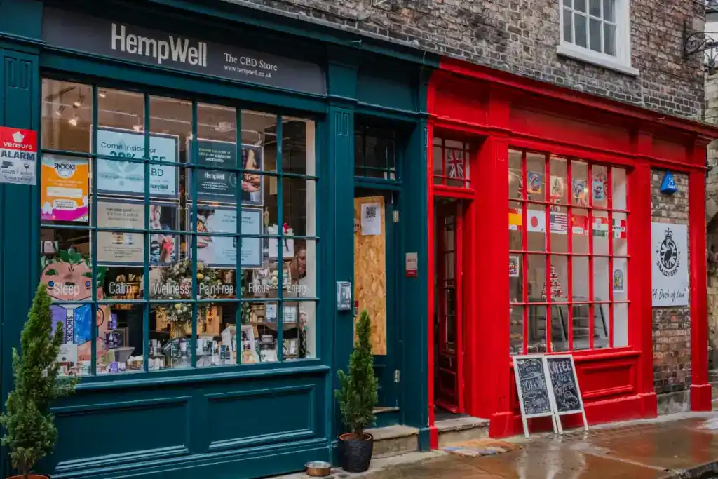 Exterior view of HempWell CBD shop with colourful storefronts in a UK high street, highlighting retail property valuation based on rental income.