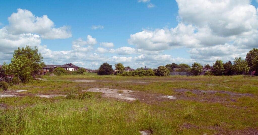 Vacant land site suitable for property development or investment opportunities with open grassy areas and surrounding residential neighbourhoods.