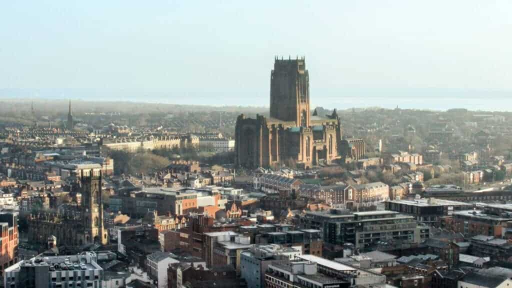 An aerial view of a historic cathedral dominating the city skyline, highlighting the transformation of commercial properties into residential spaces in the UK.