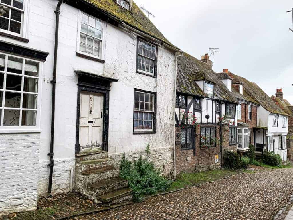 Cracked and weathered old cottage with mossy roof and charming traditional style. Perfect for property renovation and restoration projects, showcasing historical character and potential for property saviour solutions.