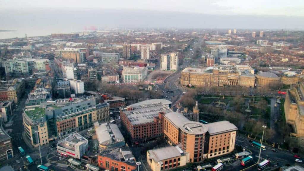 Aerial view of a bustling city with commercial buildings and roads, illustrating urban property development and investment opportunities.