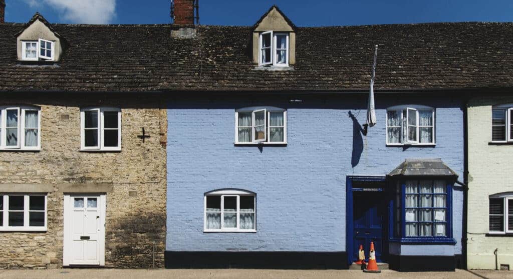 Freshly painted blue house fa&ccedil;ade showcasing property renovation and preservation. Expert property repair and restoration services referenced as Property Saviour.