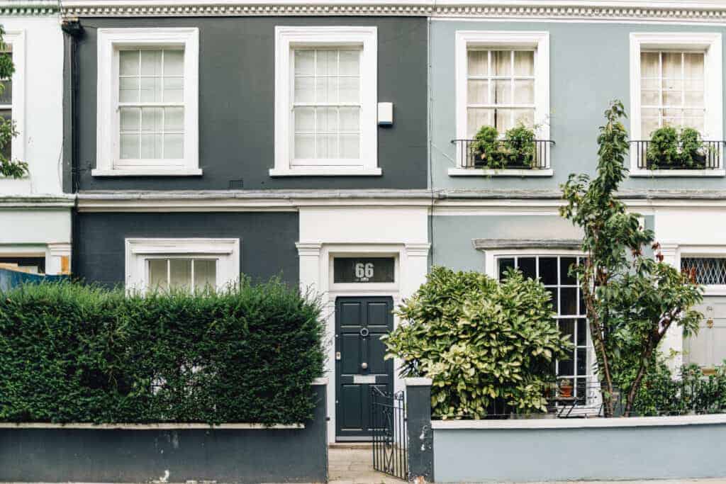 Bright colourful terraced house with well maintained garden, front door, and windows, offering expert property management and property saviour services for homeowners in the UK.