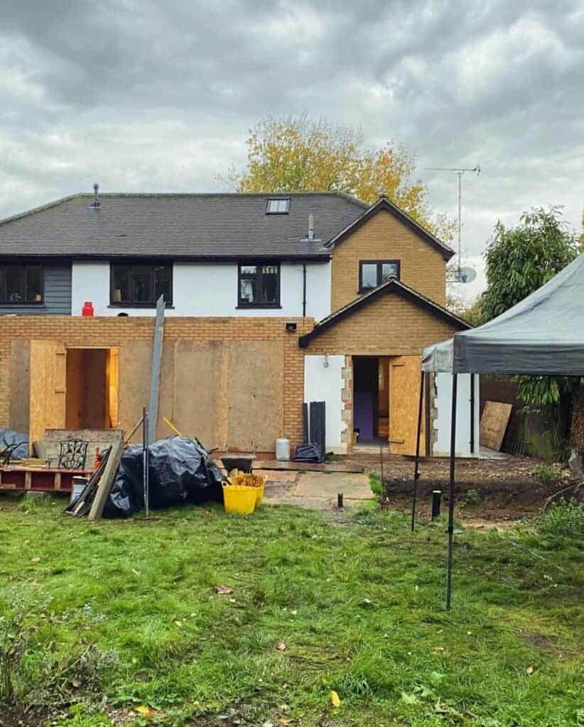 1. Extension construction underway at a residential property, featuring partially built walls and garden area, demonstrating renovation and building expertise.